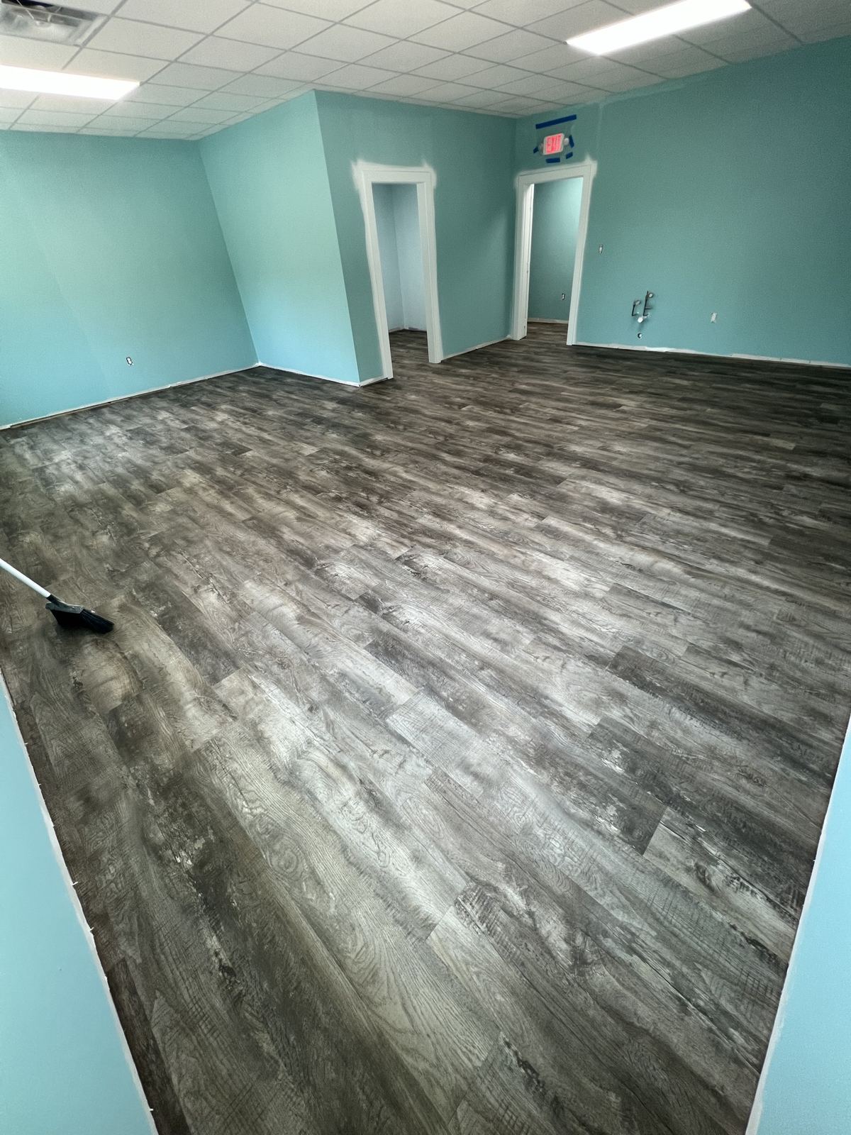 Gray wood-look plank floor in an empty commercial office space