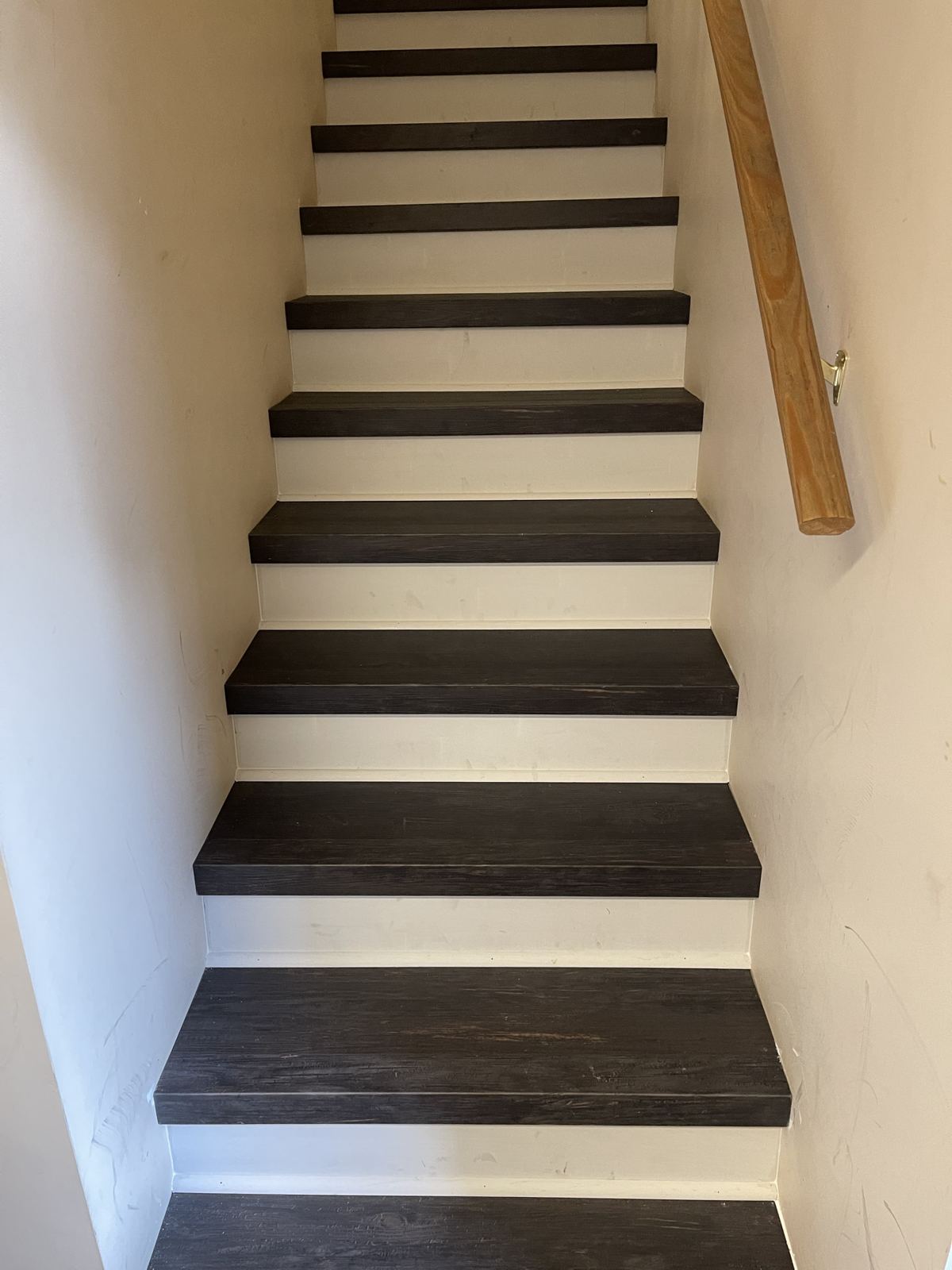 Charcoal stair treads with white risers on a straight staircase