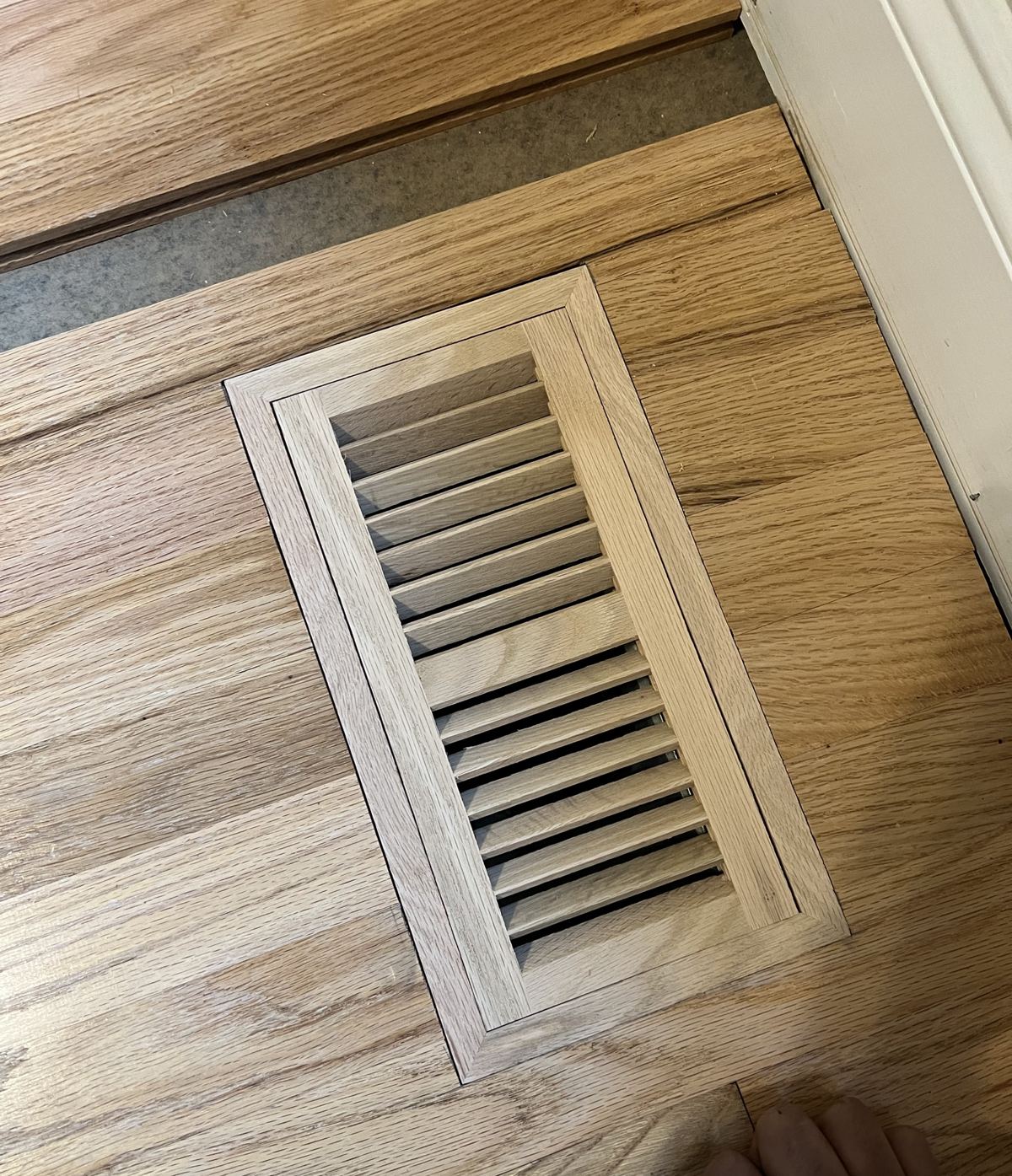 Close-up of an oak floor vent set flush into an oak floor