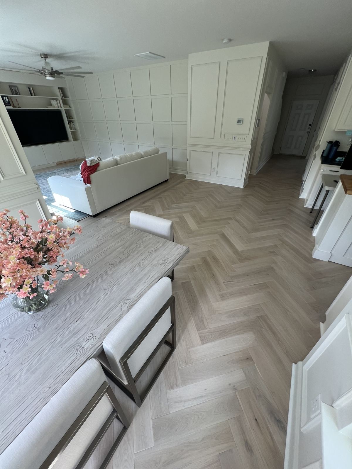 Light oak herringbone floor in an open dining and living area